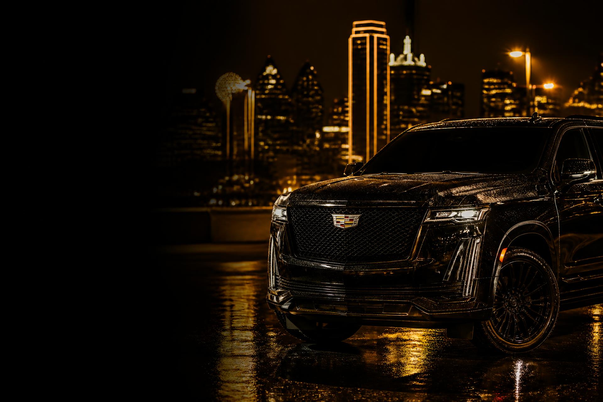 Glossy black luxury SUV on wet asphalt with the Dallas skyline glowing gold at night